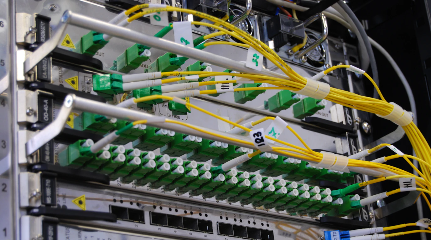 Labeled fiber optic cables connected to network equipment in a server rack